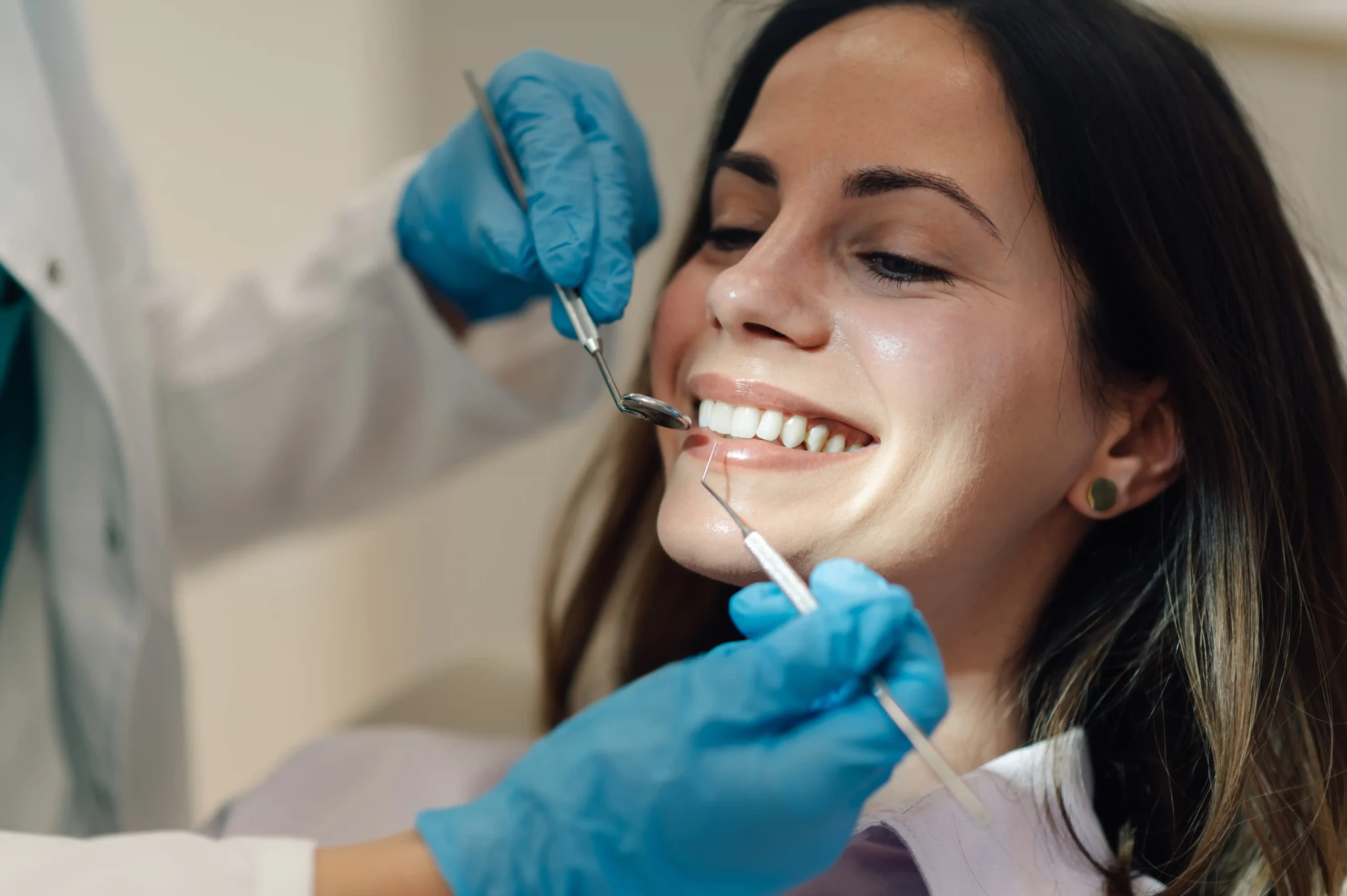 Patient getting her teeth checked at a general/family dentist appointment